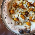 Homemade Neapolitan style pizza topped with mozzarella, pumpkin, blue cheese, pine nuts, oregano and EVOO. Baked in our Ooni outdoor pizza oven.