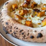 Homemade Neapolitan style pizza topped with mozzarella, pumpkin, blue cheese, pine nuts, oregano and EVOO. Baked in our Ooni outdoor pizza oven.