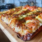 Homemade Detroit style pizza topped with mozzarella, grana pdano, Neapolitan style tomato sauce, oregano and EVOO. Baked in our Ooni Volt pizza oven.