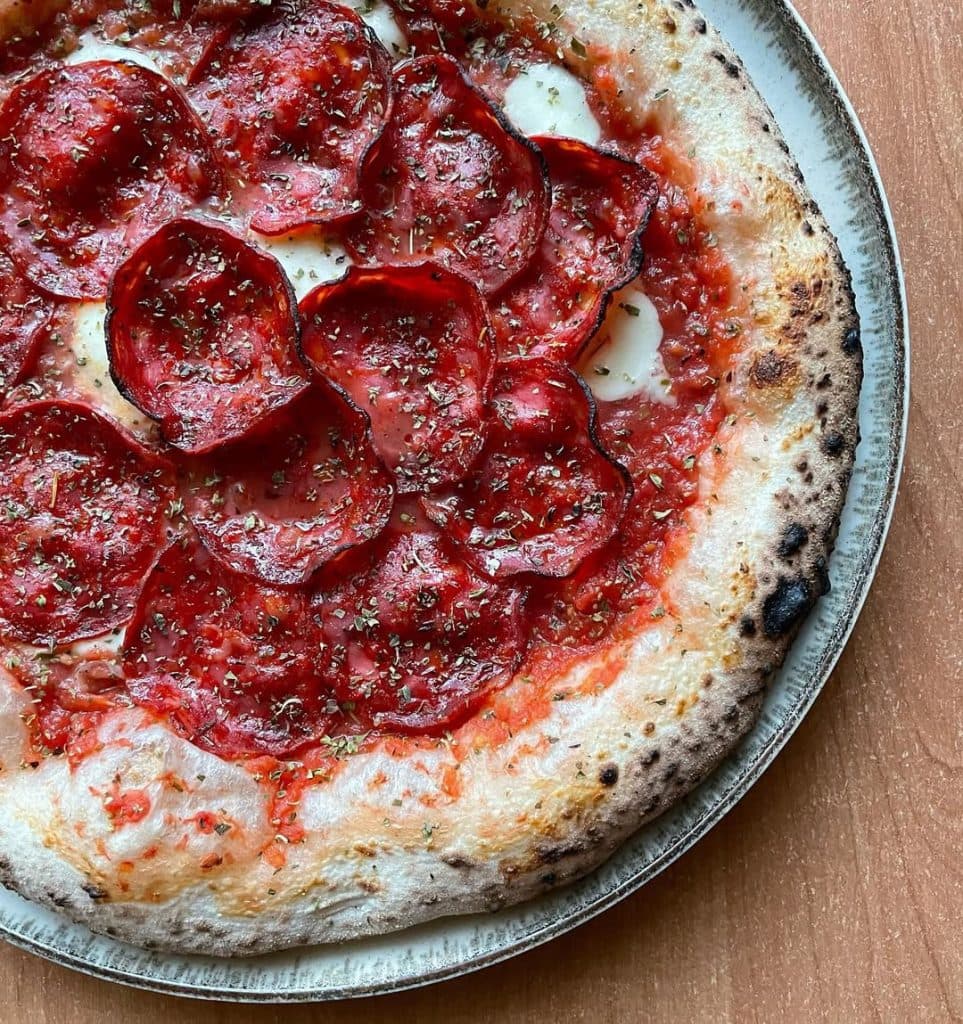 Spanish chorizo pizza baked in Ooni outdoor pizza oven.