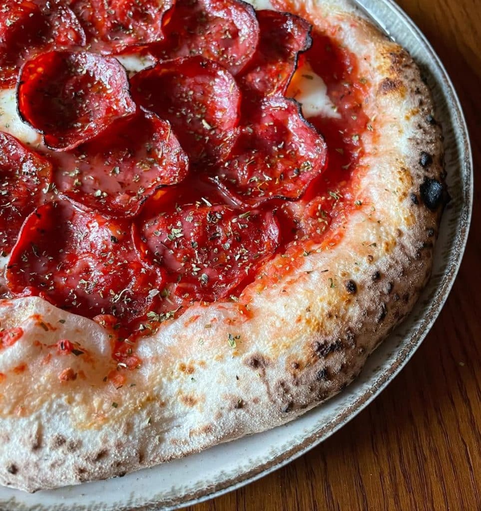 Spanish chorizo pizza baked in Ooni outdoor pizza oven.