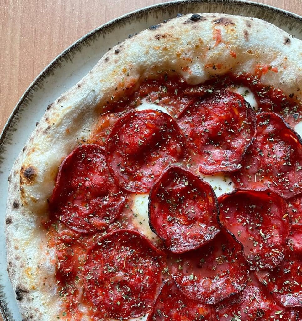 Spanish chorizo pizza baked in Ooni outdoor pizza oven.