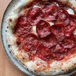 Spanish chorizo pizza baked in Ooni outdoor pizza oven.