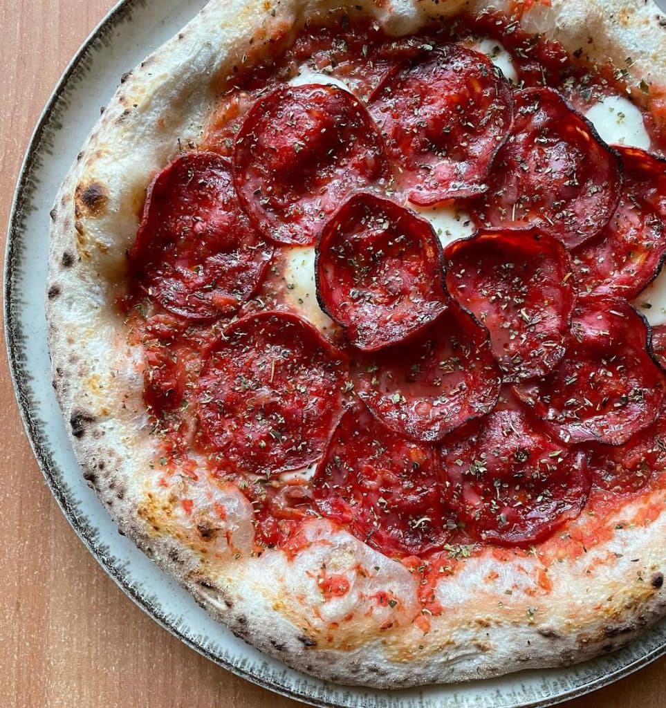 Spanish chorizo pizza baked in Ooni outdoor pizza oven. 